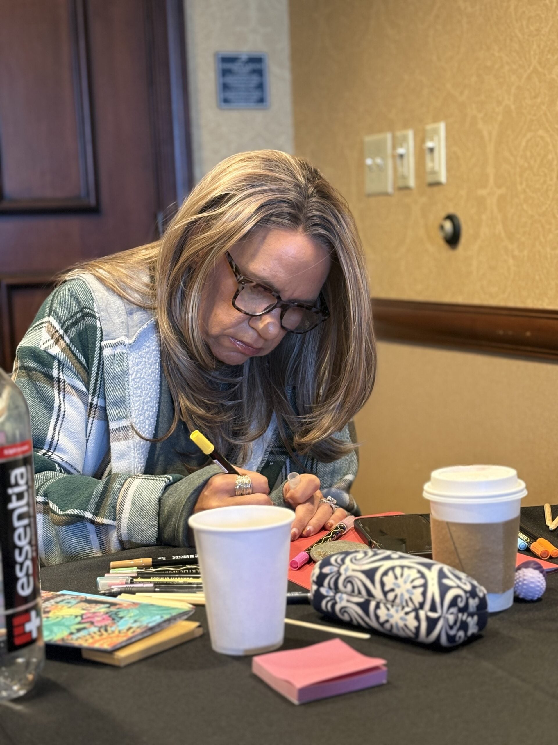 A retreat participant engaged in a quiet creative reflection activity